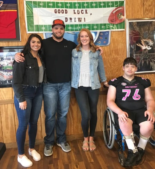 Drew with his brother, sister and wife Emily(middle)